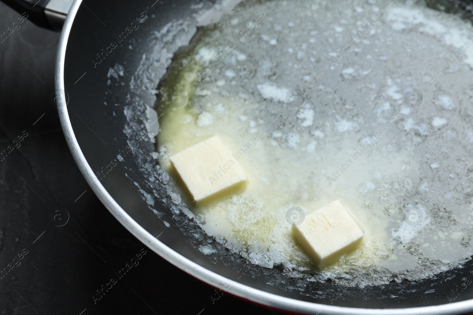 Photo of Melting butter in frying pan, closeup view