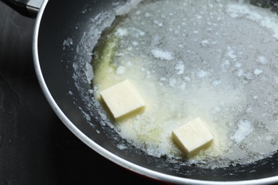 Photo of Melting butter in frying pan, closeup view