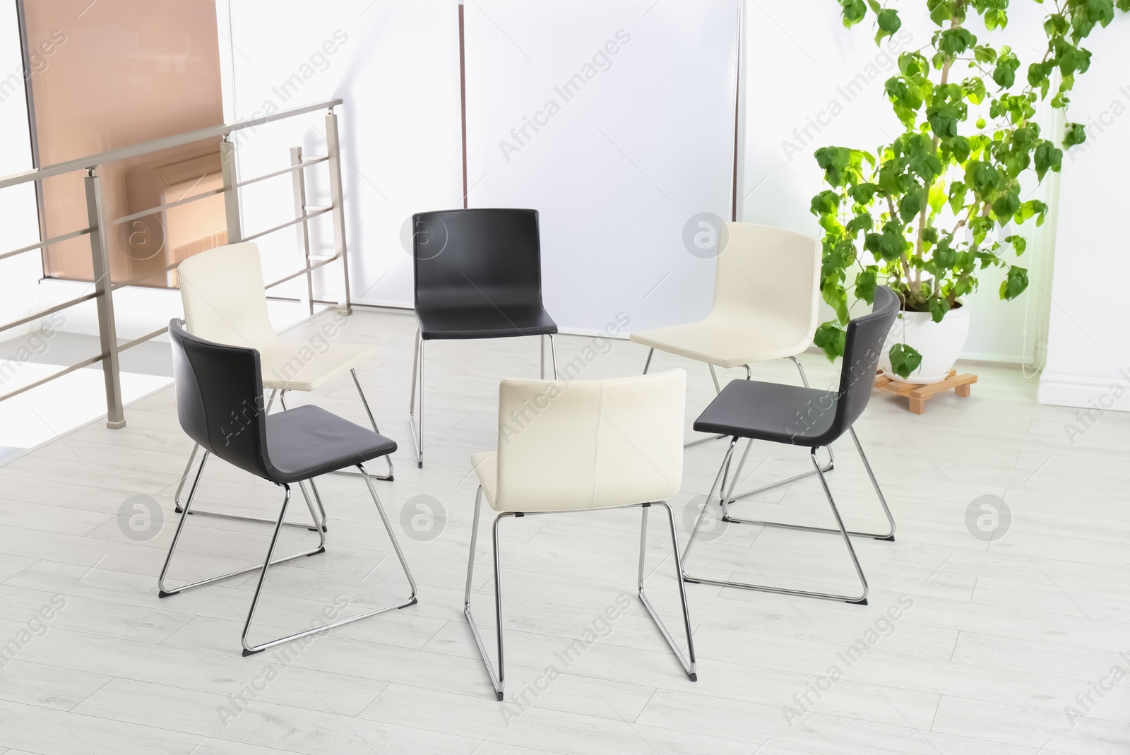 Photo of Empty chairs prepared for group psychotherapy session indoors