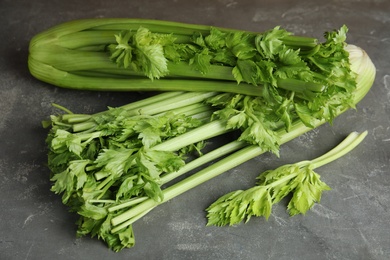 Fresh ripe green celery on grey table