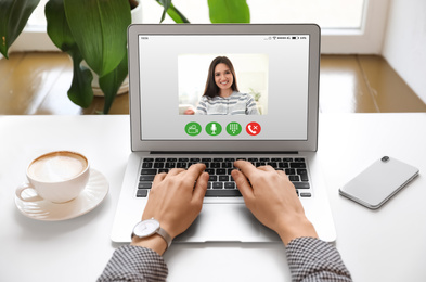 Woman having online meeting with her colleague via laptop, closeup