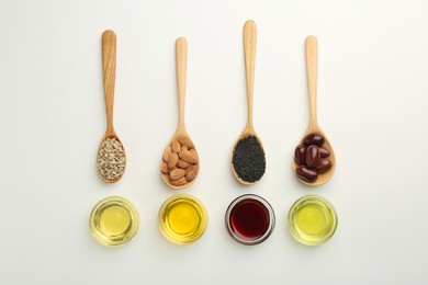 Photo of Vegetable fats. Different cooking oils in bowls and spoons with ingredients on white background, flat lay