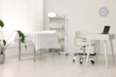 Blurred view of dermatologist's office with examination table