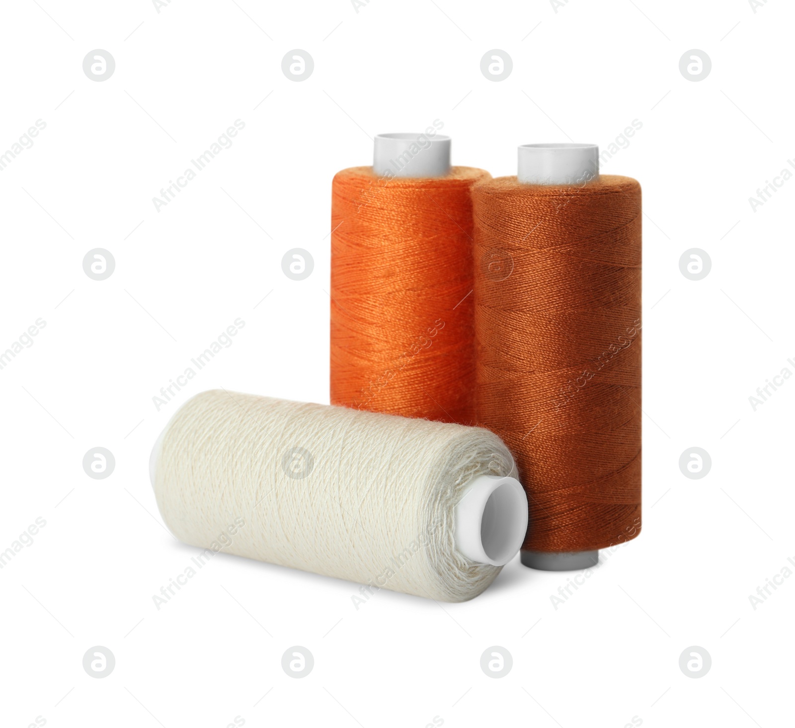 Photo of Different colorful sewing threads on white background