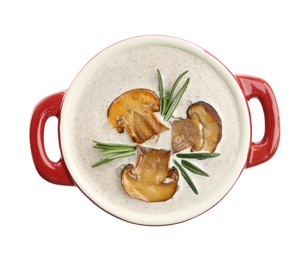 Photo of Fresh homemade mushroom soup in ceramic pot isolated on white, top view