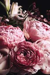 Photo of Beautiful bouquet of different flowers on black background, closeup. Floral card design with dark vintage effect