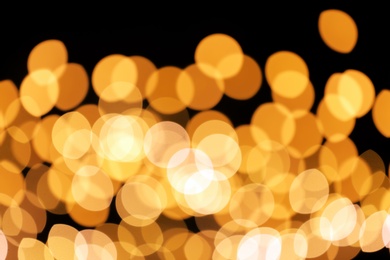 Beautiful golden lights on dark background. Bokeh effect