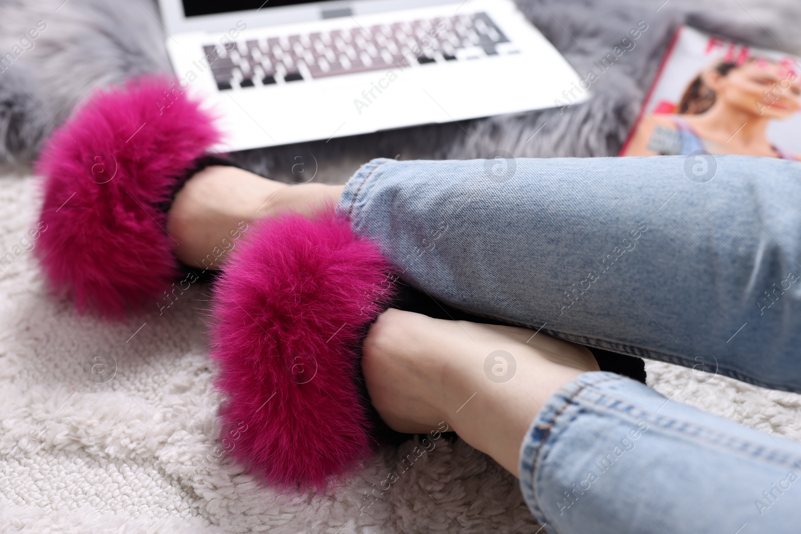 Photo of Woman in soft slippers at home, closeup