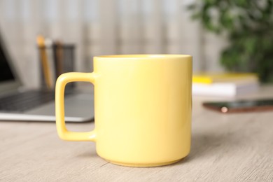 Photo of Mug of hot drink on white wooden table in office. Coffee Break