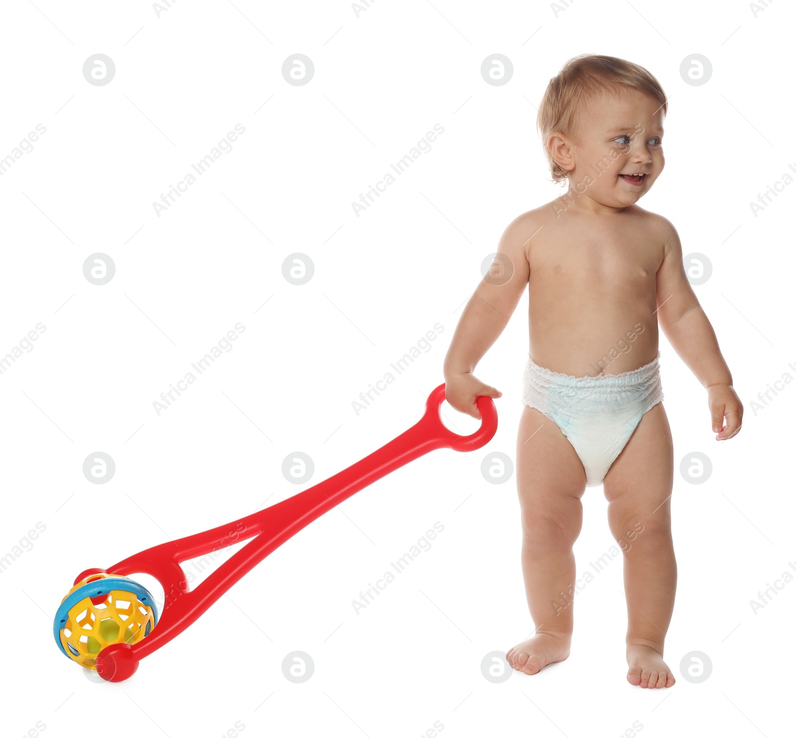 Photo of Cute baby with push toy learning to walk on white background