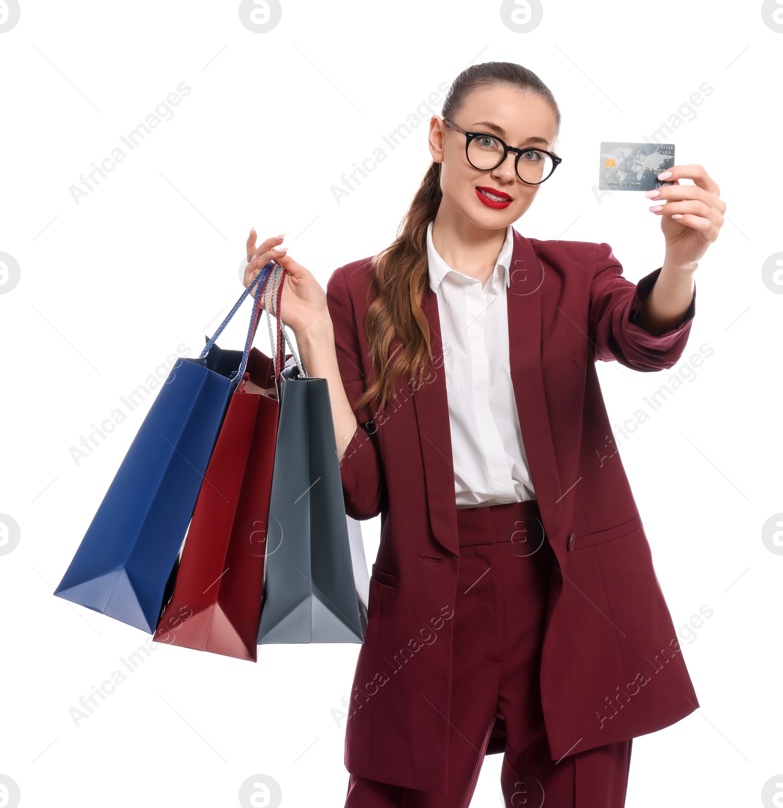 Photo of Stylish young businesswoman with shopping bags and credit card on white background