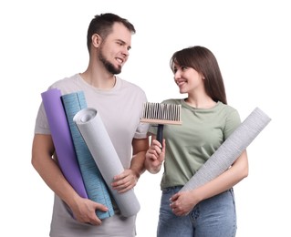 Photo of Couple with wallpaper rolls and brush on white background