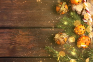 Image of Flat lay composition with pomander balls of fresh tangerines and cloves on wooden background, space for text. Christmas decoration