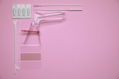 Sterile gynecological examination kit and medicaments on pink background, flat lay. Space for text