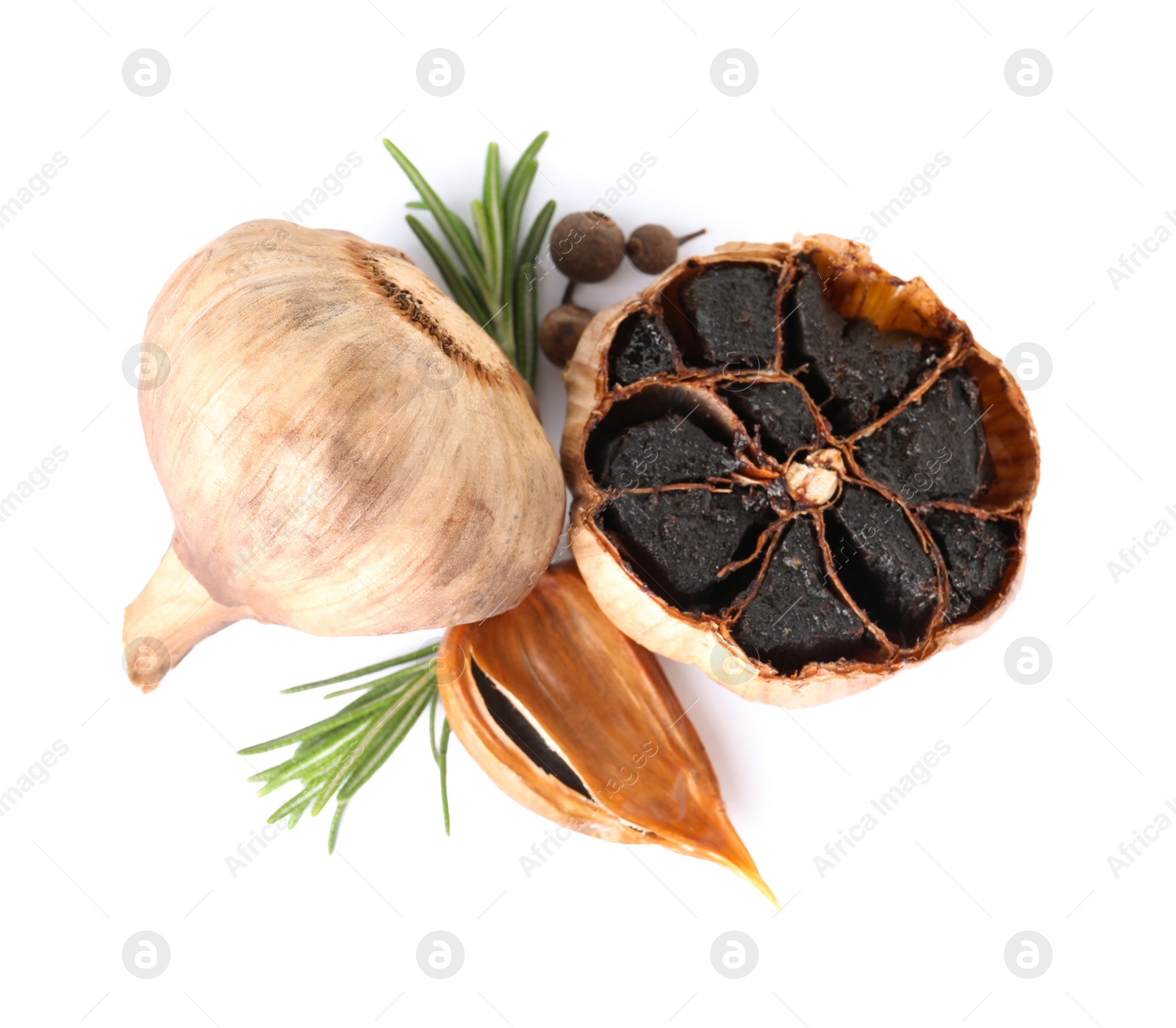 Photo of Aged black garlic with rosemary on white background, view from above