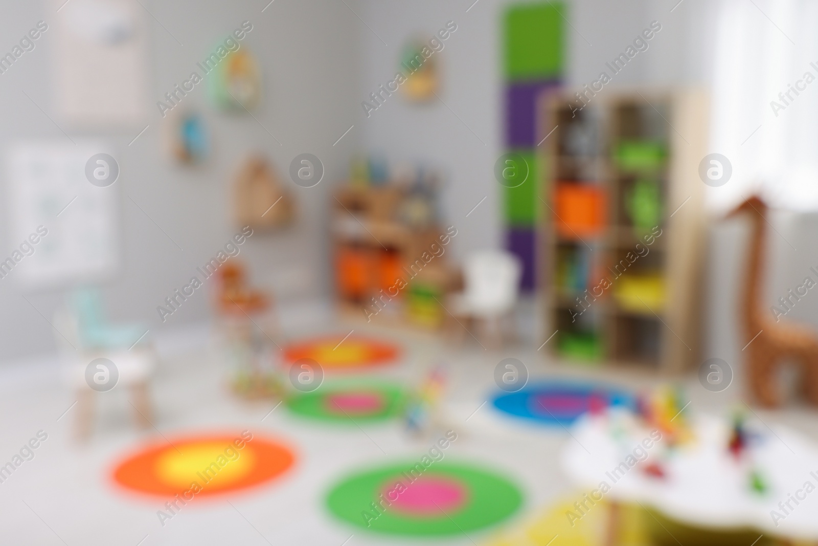 Photo of Blurred view of child`s playroom. Kindergarten interior