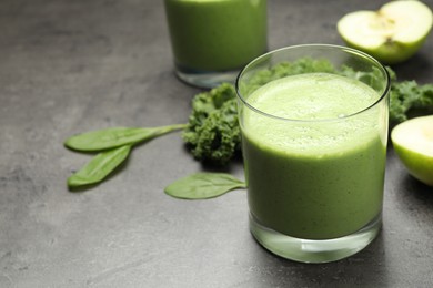 Photo of Tasty fresh kale smoothie on grey table, closeup