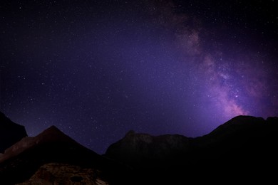 Image of Picturesque view of starry night sky over mountains