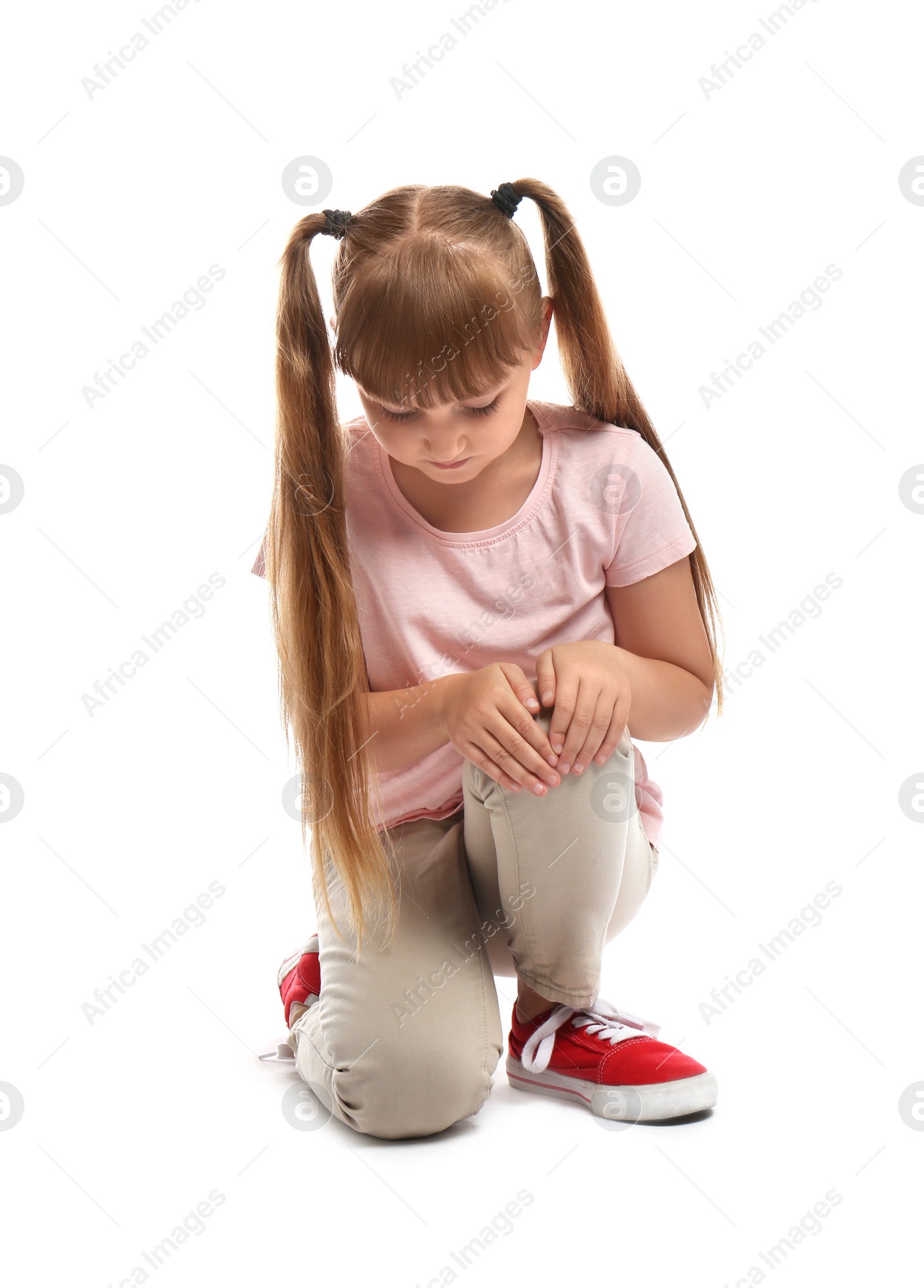 Photo of Full length portrait of little girl suffering from knee problems on white background