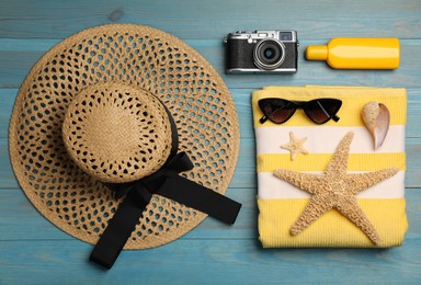 Photo of Flat lay composition with beach objects on light blue wooden background