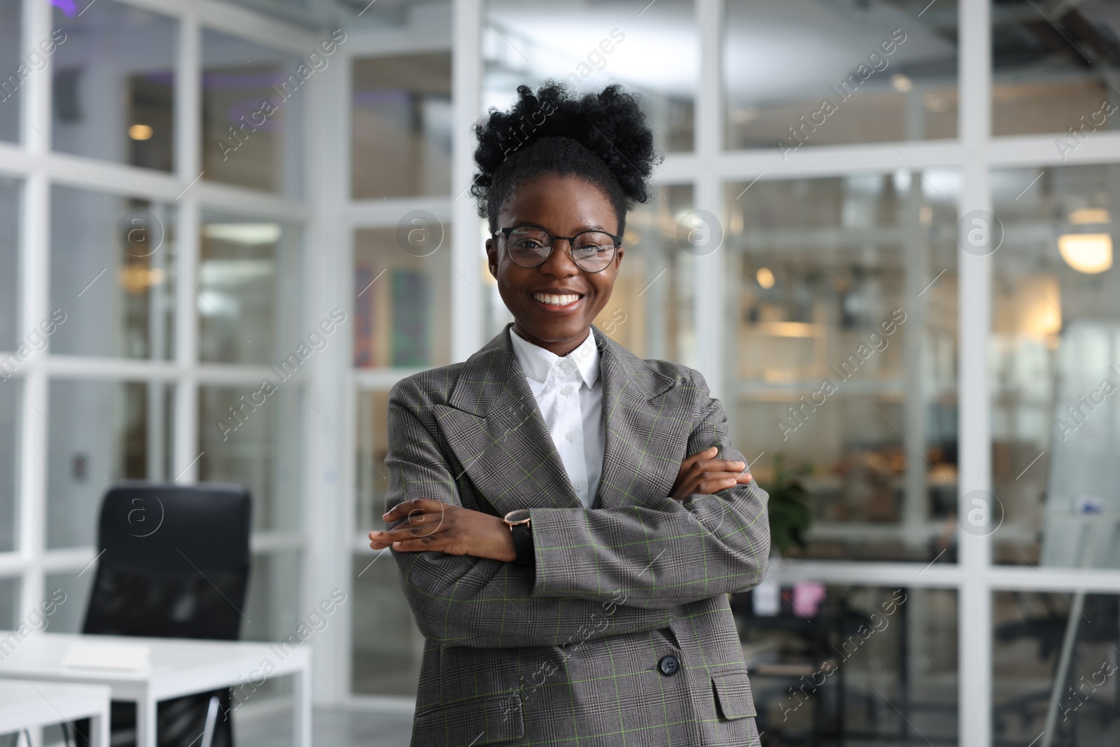 Photo of Happy woman with crossed arms in office. Lawyer, businesswoman, accountant or manager