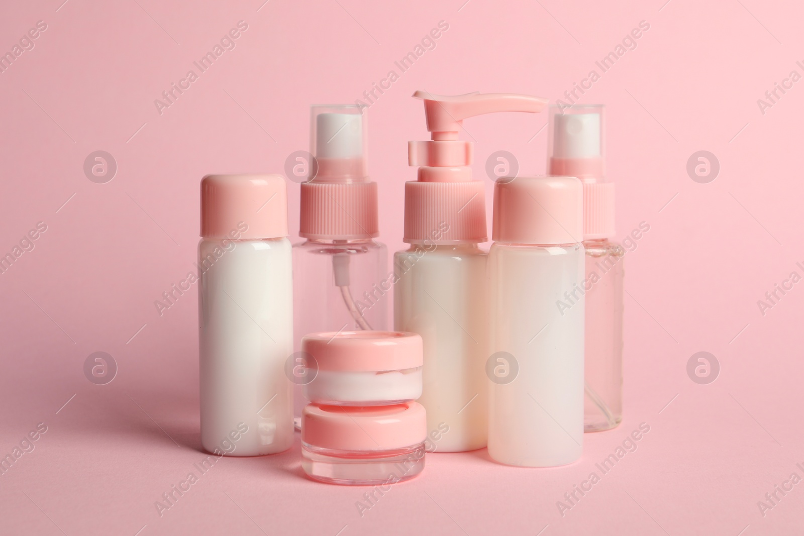 Photo of Cosmetic travel on pink background. Bath accessories