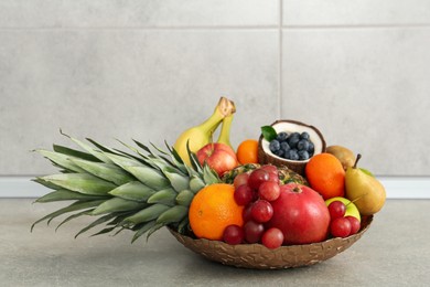 Assortment of fresh exotic fruits on grey table