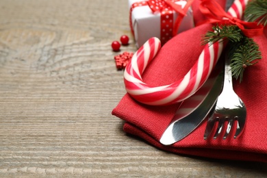 Cutlery set and festive decor on wooden table, closeup with space for text. Christmas celebration