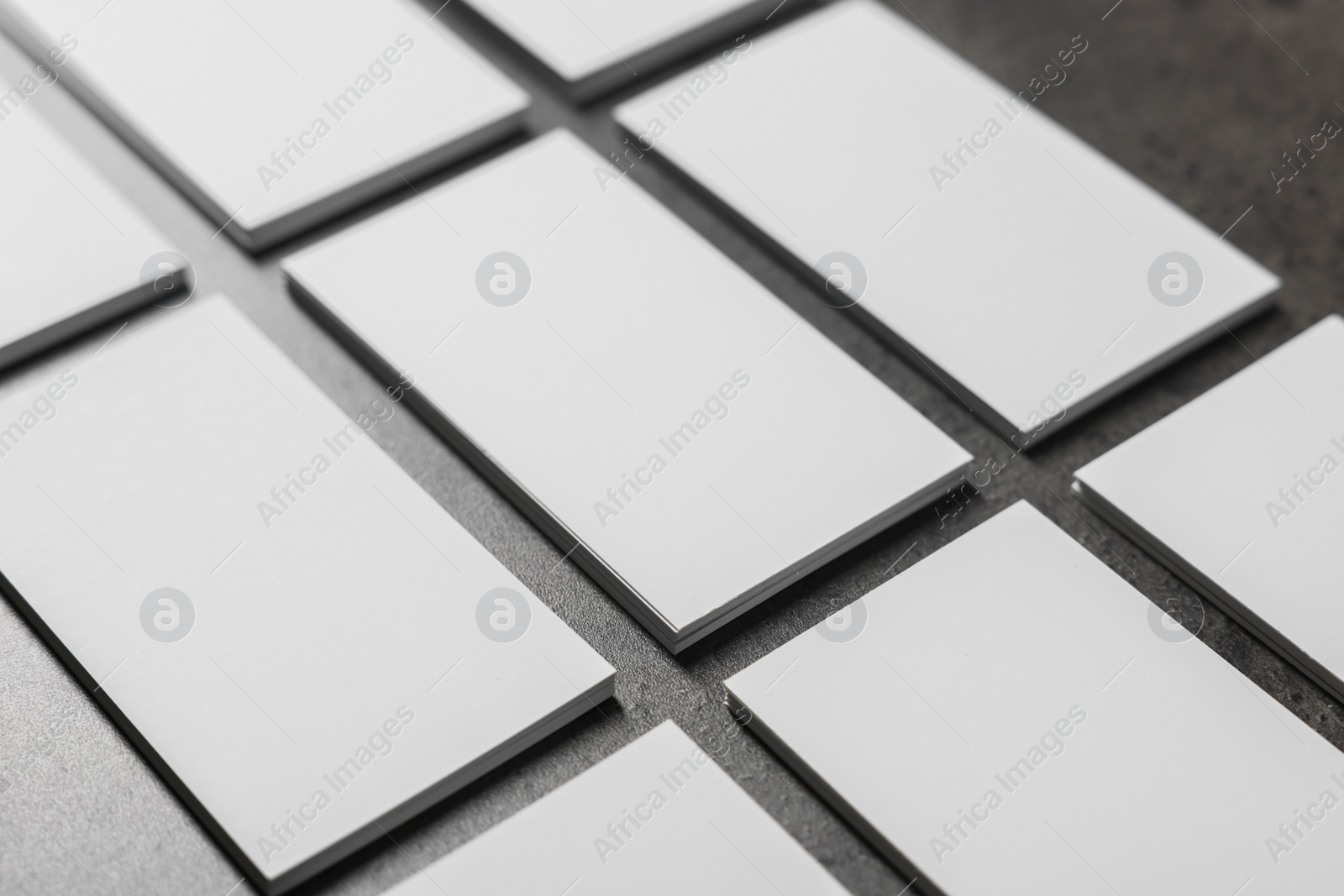 Photo of Blank business cards on grey textured table, closeup. Mockup for design