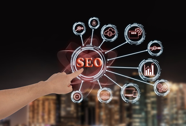 Image of SEO directions with icons of keyword research, customization and others. Man using virtual screen, closeup