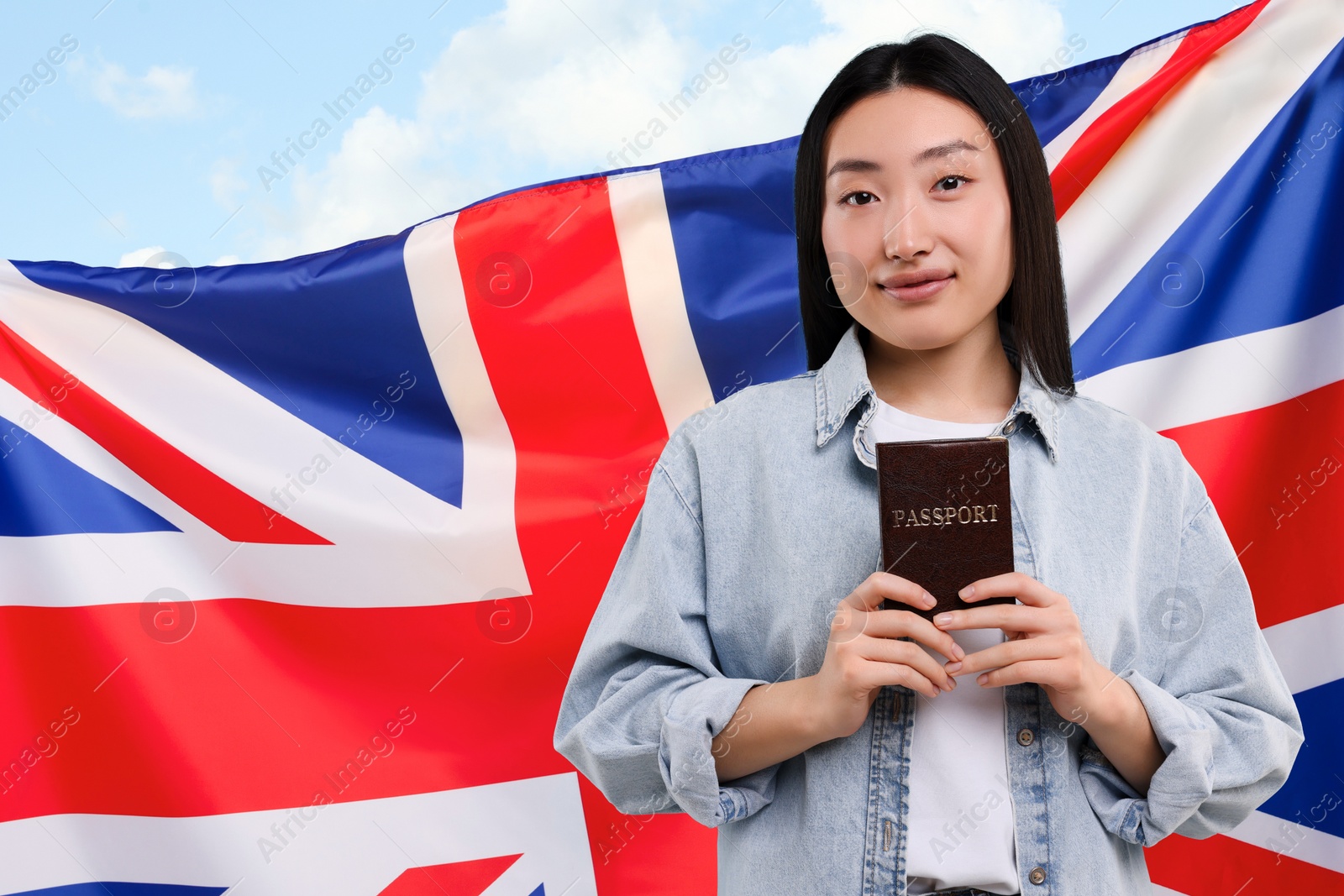 Image of Immigration. Woman with passport and national flag of United Kingdom against blue sky, space for text
