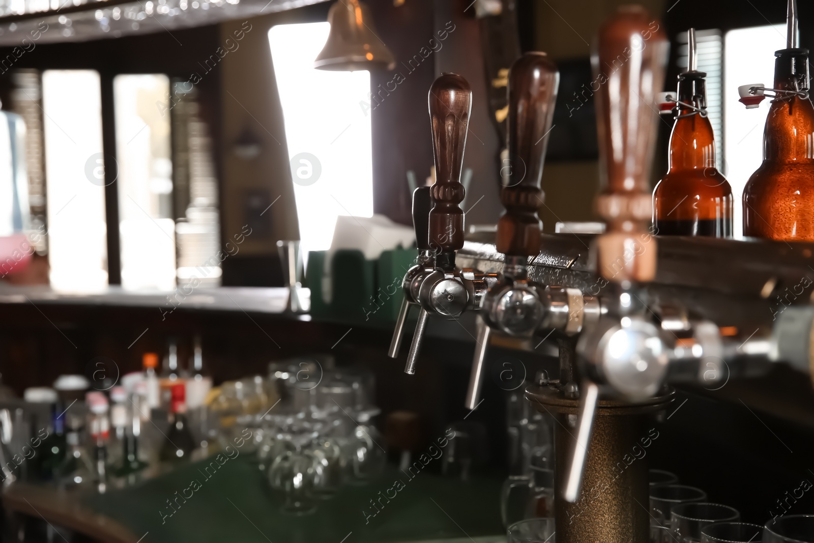 Photo of Beer taps at counter in modern bar
