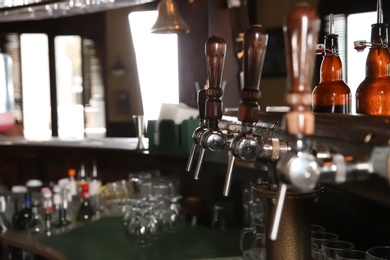 Beer taps at counter in modern bar