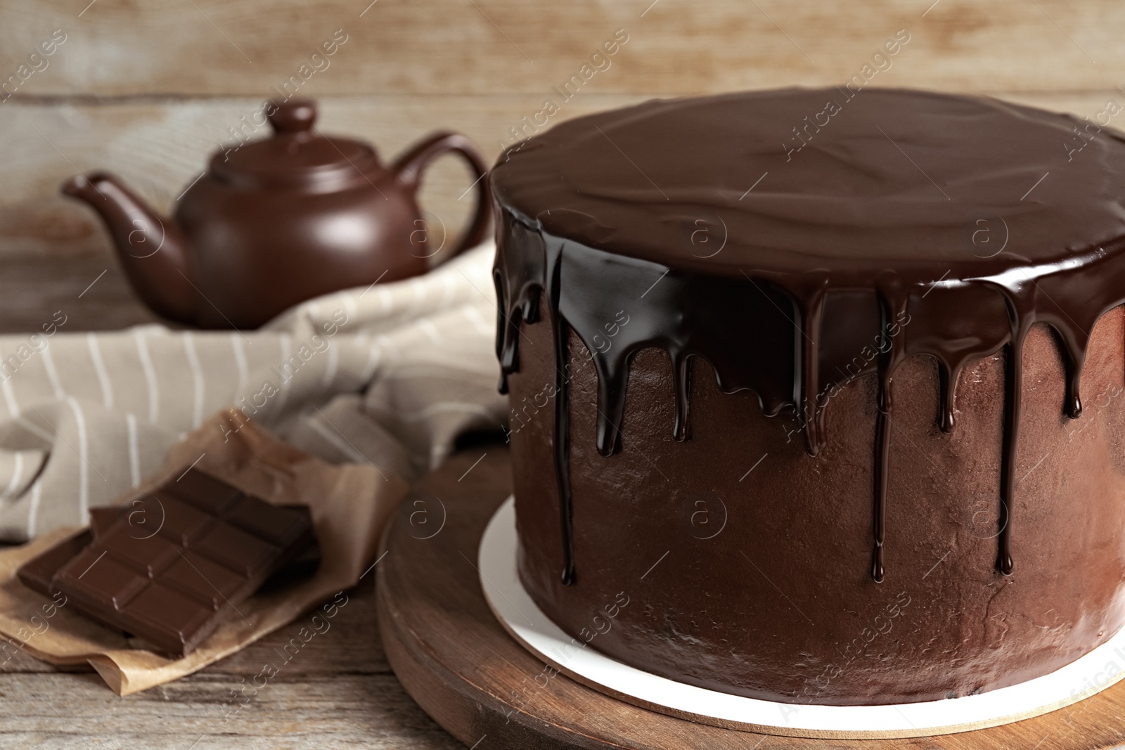 Photo of Freshly made delicious chocolate cake on wooden table, closeup