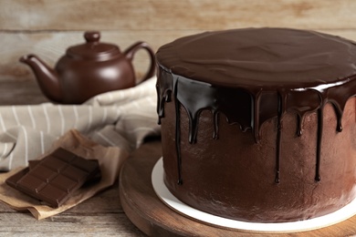 Freshly made delicious chocolate cake on wooden table, closeup