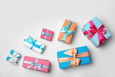 Photo of Flat lay composition with beautiful gift boxes on white background