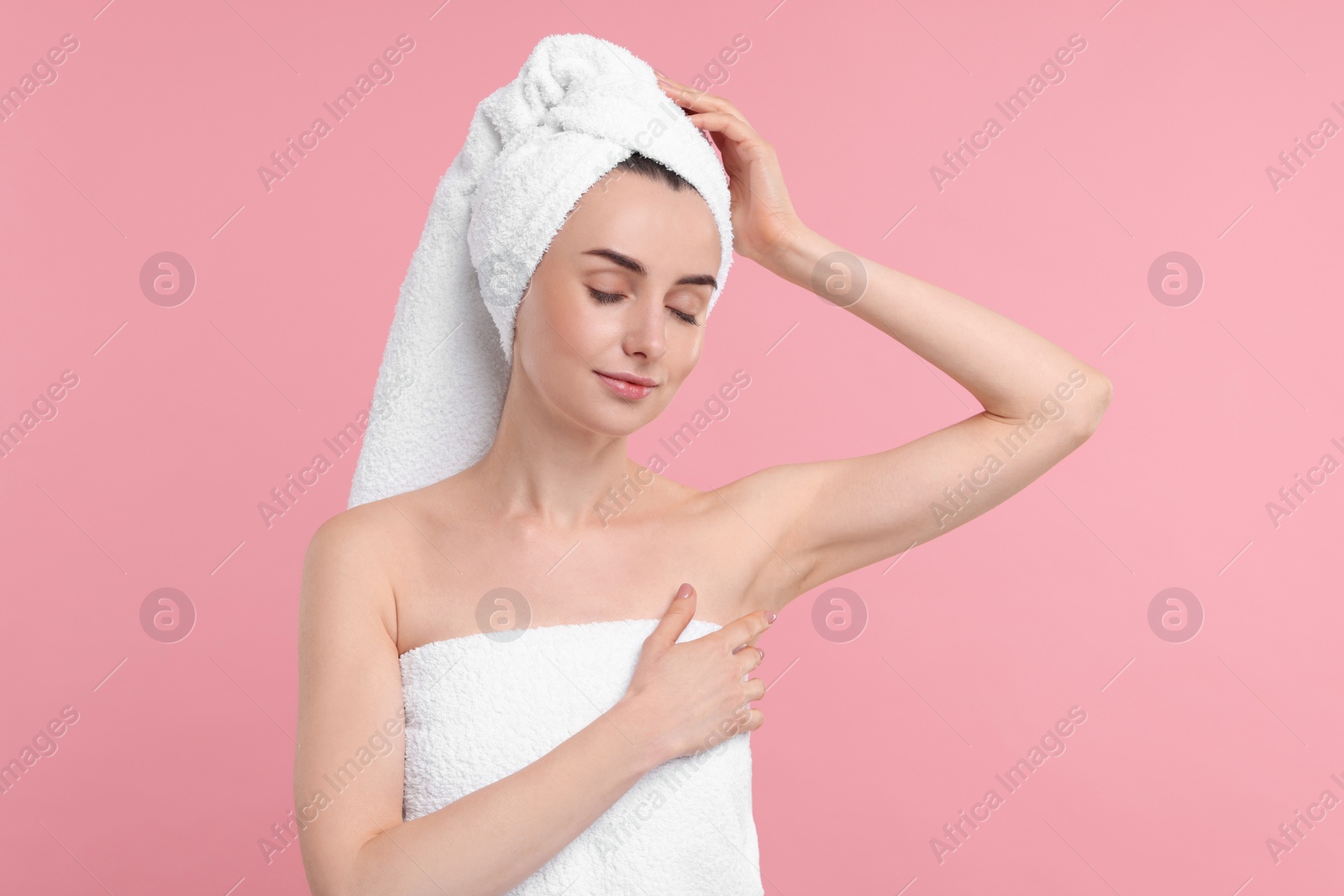 Photo of Beautiful woman showing armpit with smooth clean skin on pink background