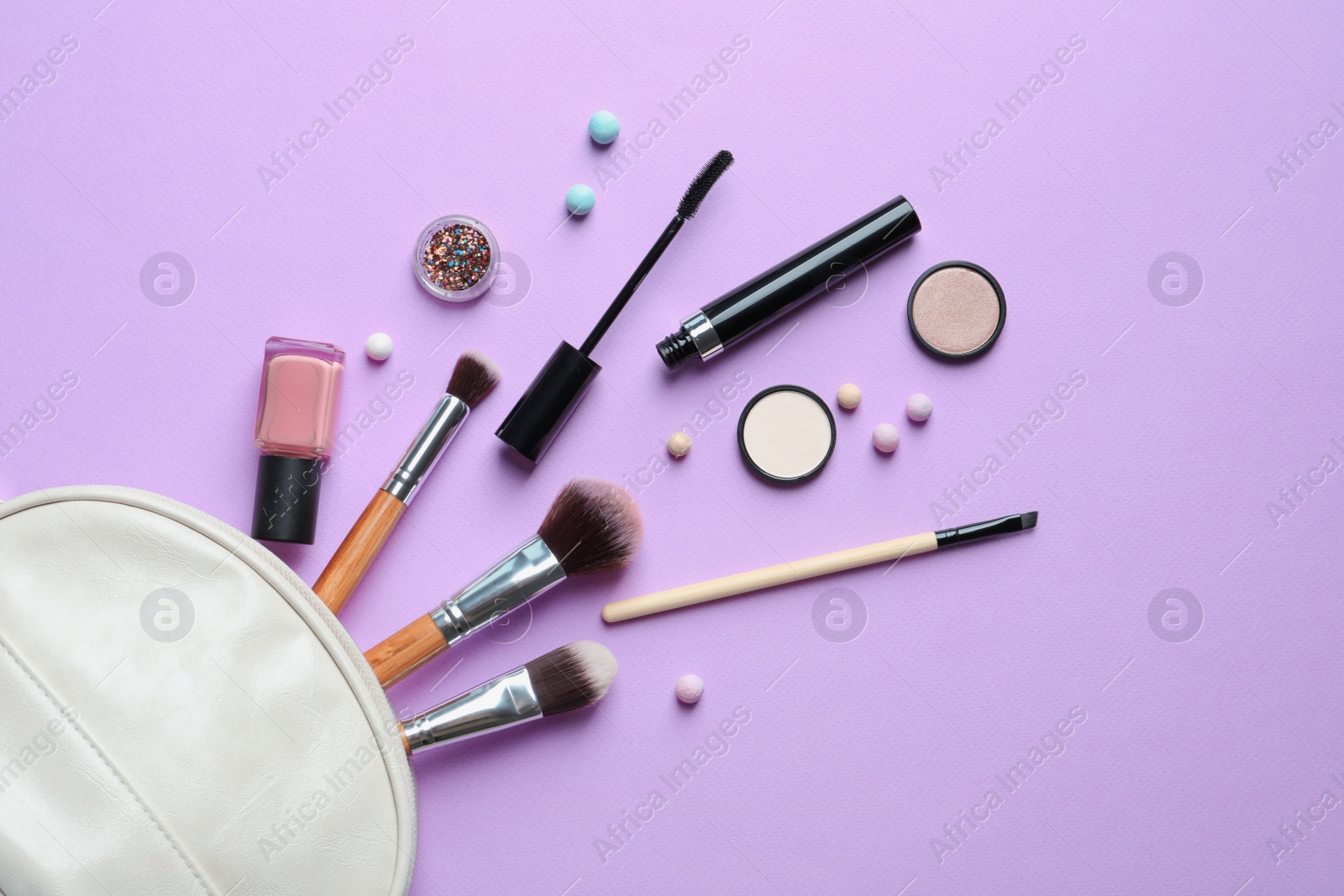 Photo of Makeup products with cosmetic bag on color background