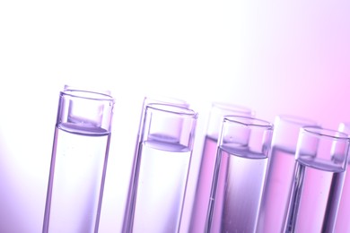 Many glass test tubes on light background, closeup