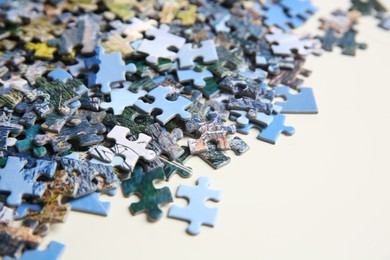 Photo of Puzzle pieces on white table, closeup view