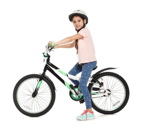 Portrait of cute little girl with bicycle on white background
