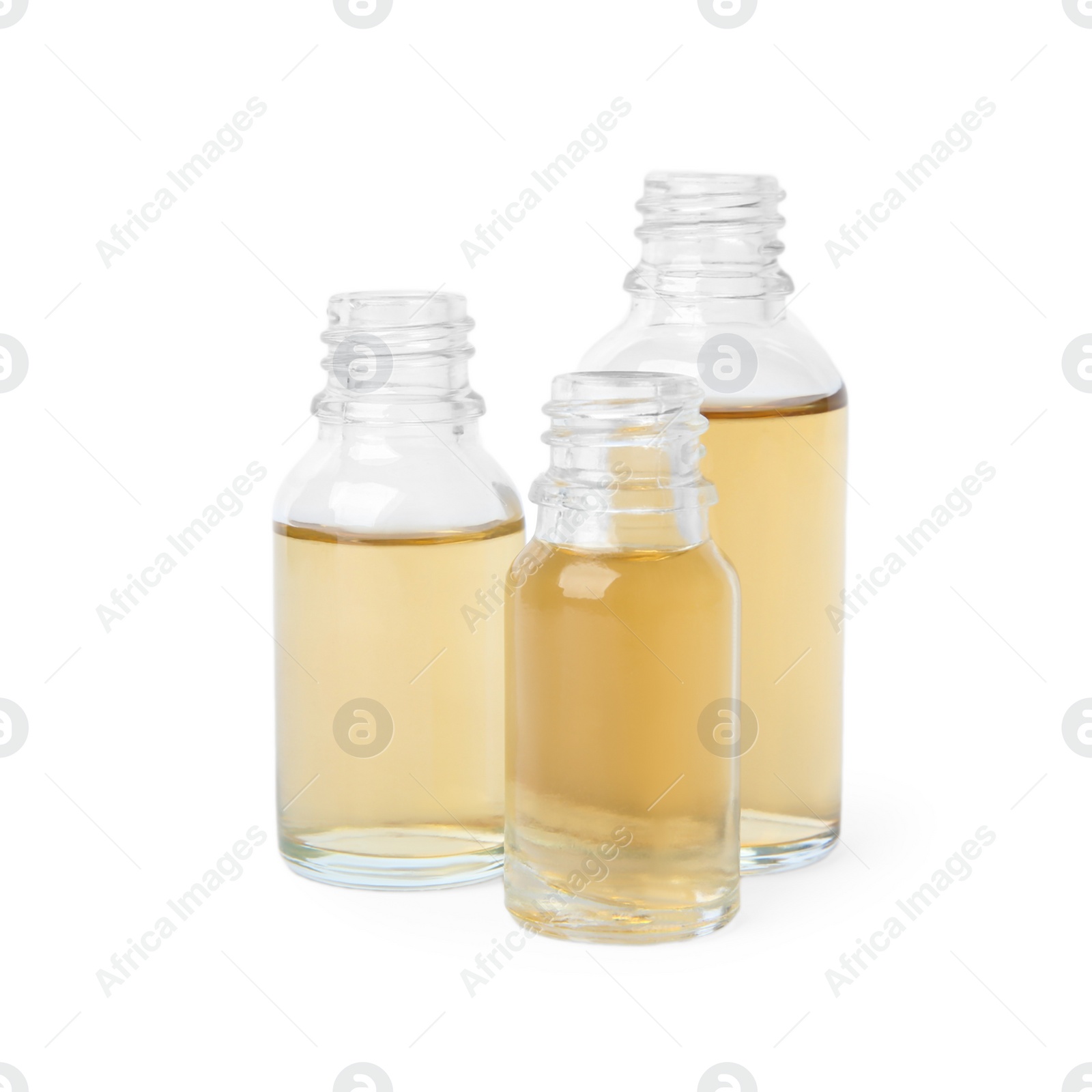 Photo of Glass bottles of essential oils on white background