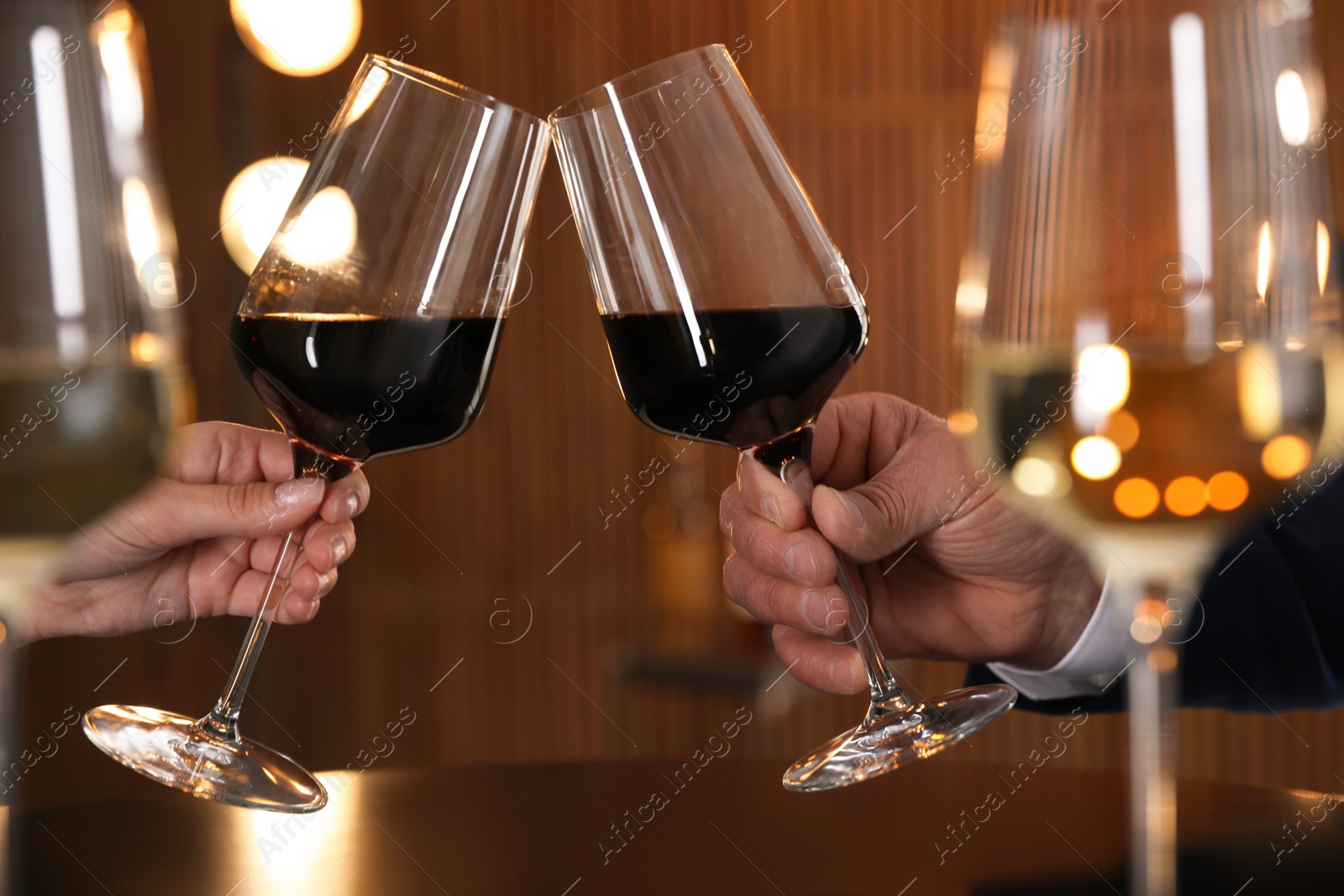 Photo of People with glasses of wine on blurred background, closeup
