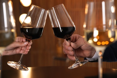 Photo of People with glasses of wine on blurred background, closeup