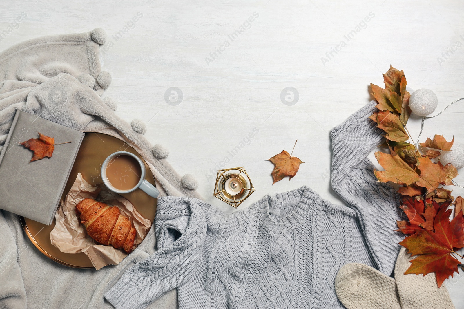 Photo of Flat lay composition with warm sweater and space for text on light background