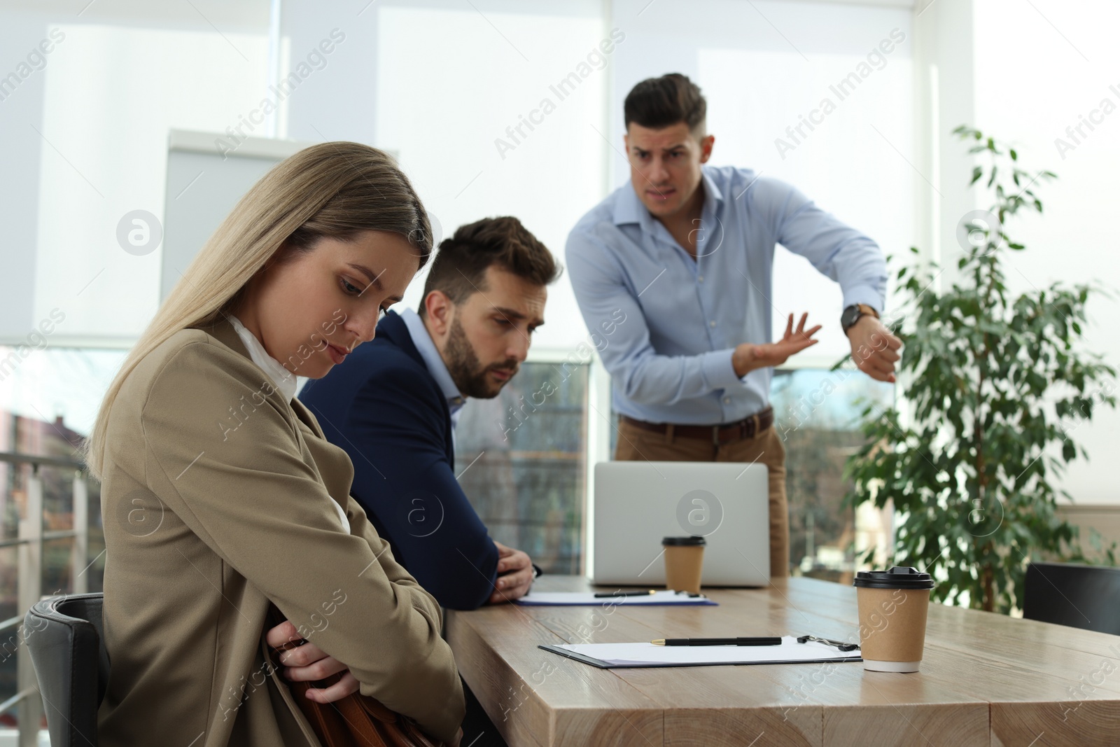 Photo of Businessman scolding employee for being late on meeting in office