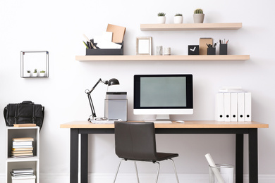 Photo of Modern computer on table in office interior. Stylish workplace