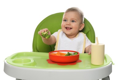 Photo of Cute little baby wearing bib while eating on white background