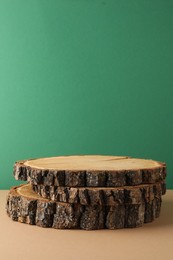 Presentation for product. Wooden stumps on color background. Space for text