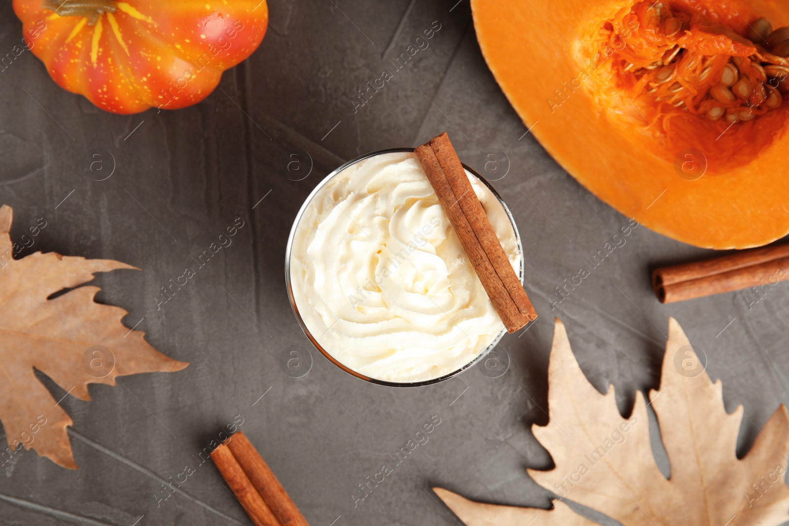 Photo of Flat lay composition with pumpkin spice latte on gray background